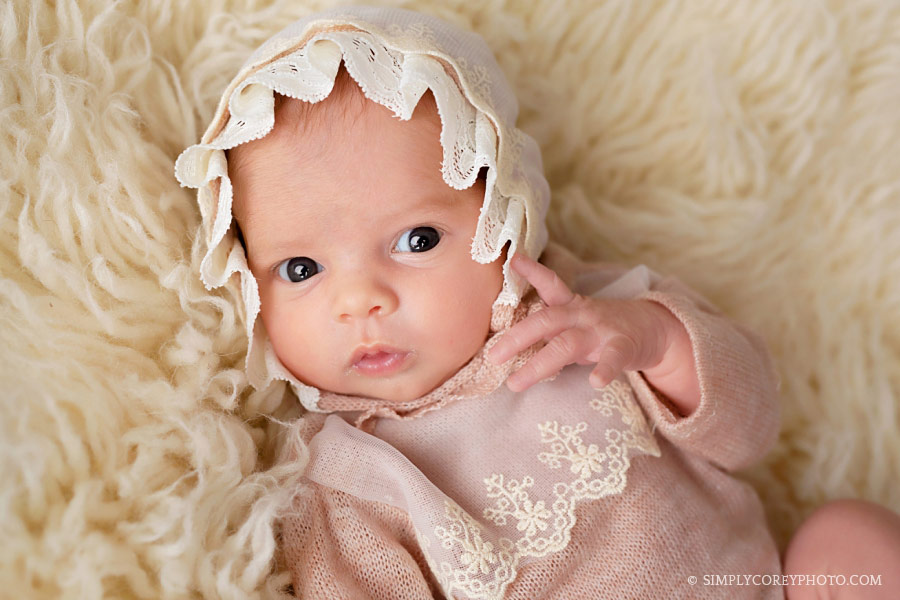 Villa Rica newborn photographer, awake baby girl with a bonnet