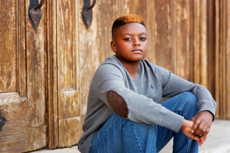 Atlanta tween photographer, boy sitting by wood doors