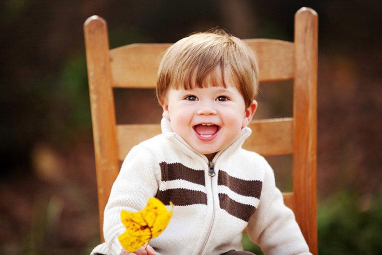 baby photographer Villa Rica, boy with a fall leaf outside