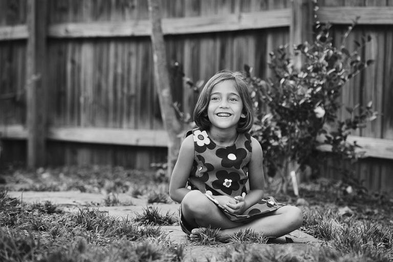 Carrollton children's photographer, child sitting on sidewalk at home