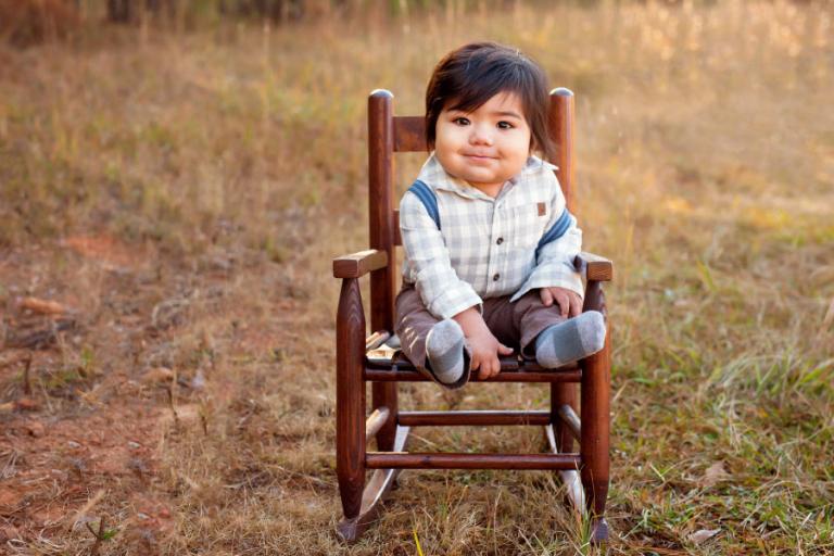 Douglasville baby photographer, boy in a rocking chair outside