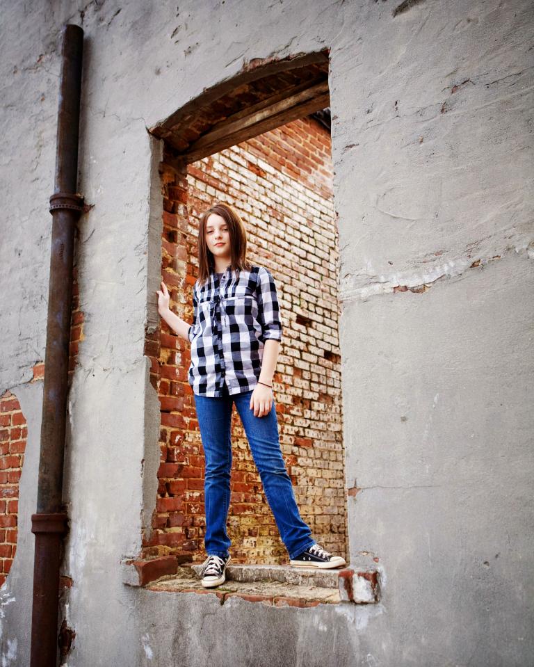 Douglasville children's photographer, girl in an old window downtown