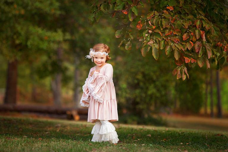 Newnan kids photographer, girl outside in Dollcakes dress