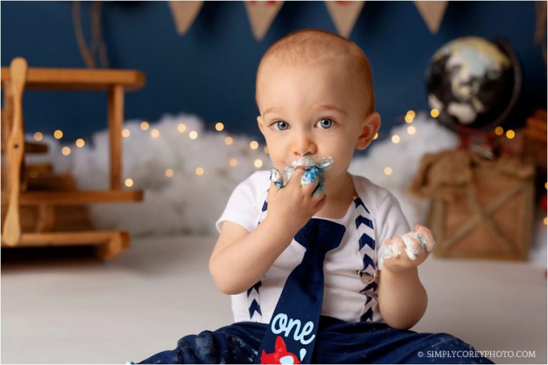 cake smash photographer Villa Rica, baby eating cake with blue frosting