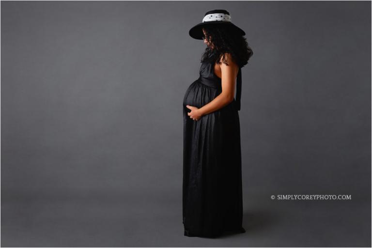 Atlanta maternity photographer, pregnant mom in black dress and floppy hat
