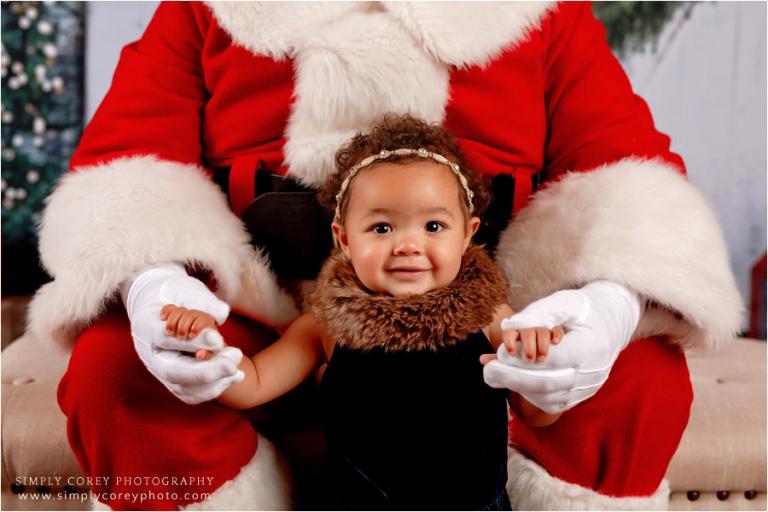 Cumming Santa Claus mini sessions, baby girl holding Santa's hands