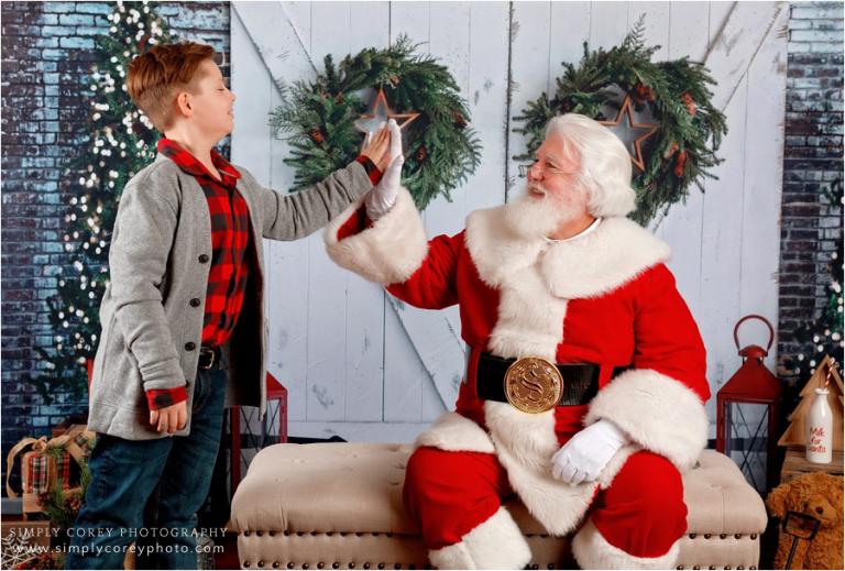 Santa Claus mini sessions near Villa Rica, boy giving Santa a high five