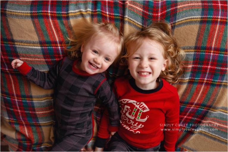 holiday pajama mini sessions near Carrollton, Georgia; siblings laughing