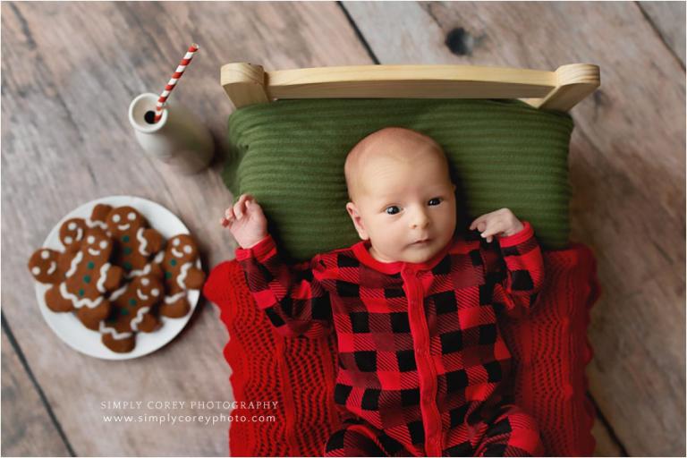 Atlanta newborn photographer, baby on bed with Christmas cookies