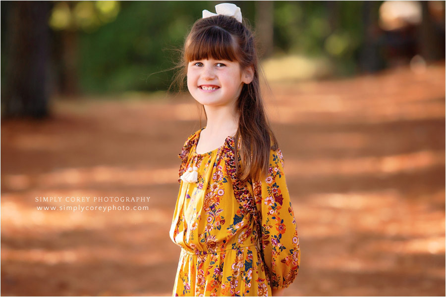 Douglasville children's photographer, girl outside in mustard dress