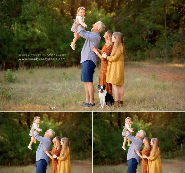 Atlanta family photographer, dad lifting toddler up in a field