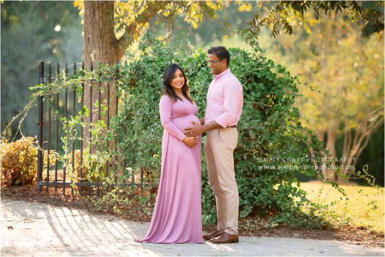 Newnan maternity photographer, expecting couple outside in pink