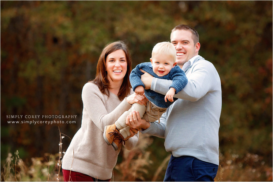 West Georgia family photographer, parents playing with baby boy outside