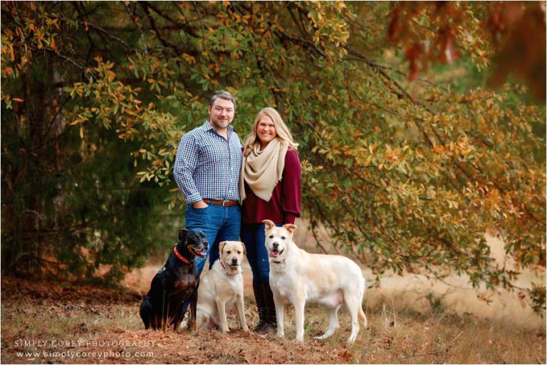 Villa Rica pet photographer, couple with three big dogs by fall tree