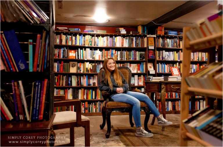 Carrollton senior portrait photographer, teen sitting in underground bookstore