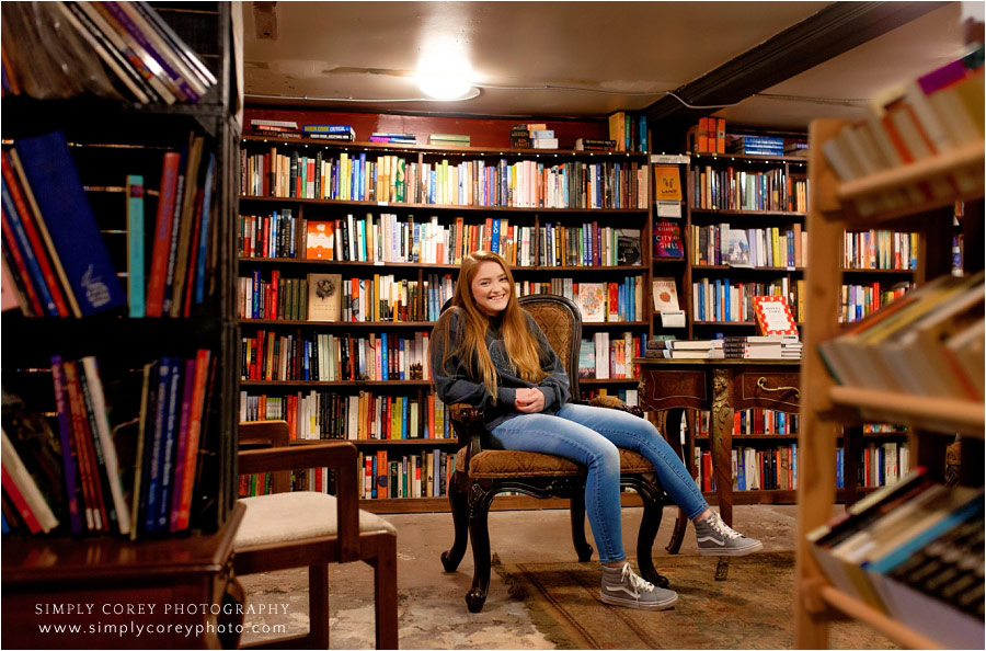 Carrollton senior portrait photographer, teen sitting in underground bookstore