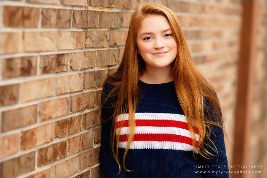 Douglasville senior portrait photographer, teen headshot on brick wall