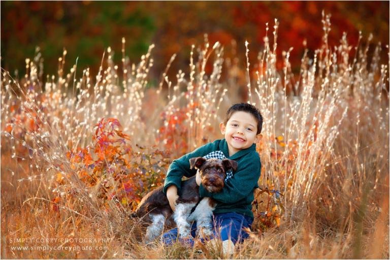Atlanta pet photographer, child and dog outside in fall field