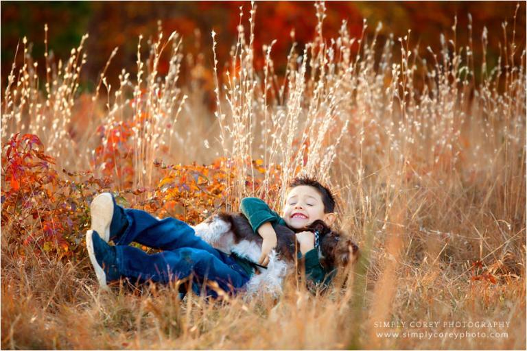 West Georgia pet photographer, outtake of child and dog falling outside