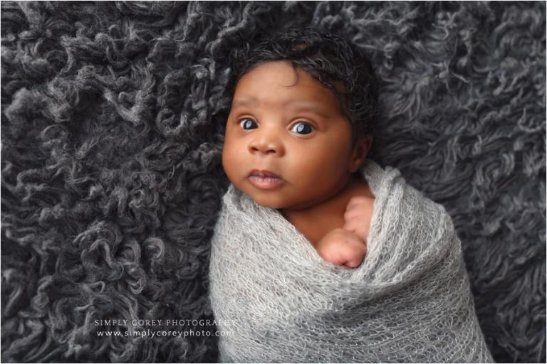 Atlanta newborn photographer, awake baby boy in grey wrap