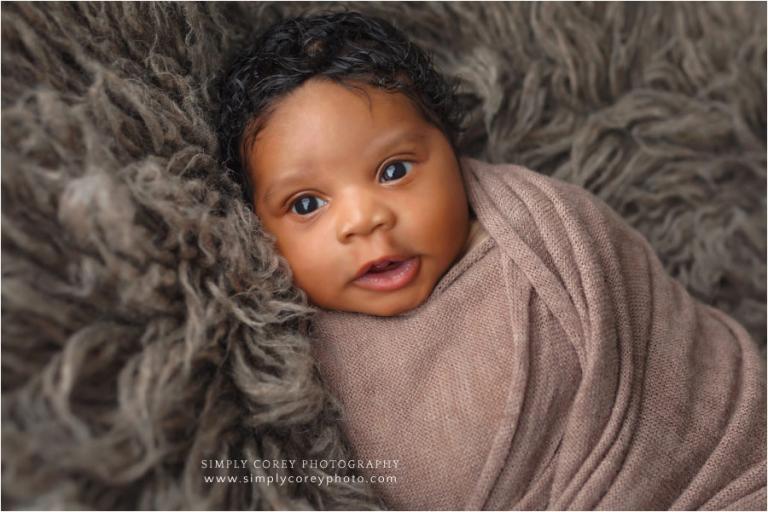 Carrollton newborn photographer, awake baby on brown fur