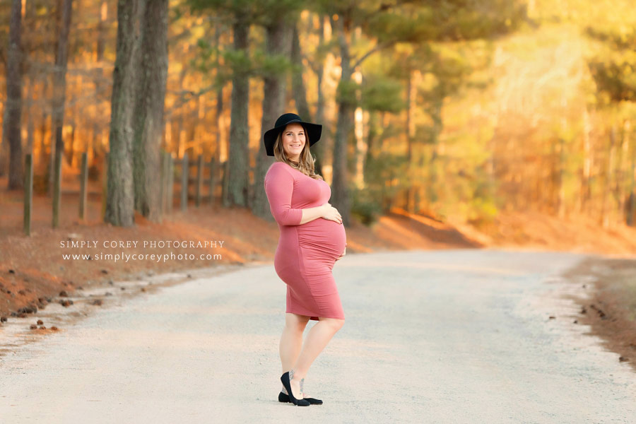 West Georgia maternity photographer, mom in pink dress outside in country