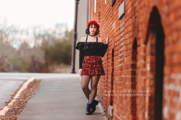 Atlanta photographer, girl in red by a brick wall for fashion shoot downtown
