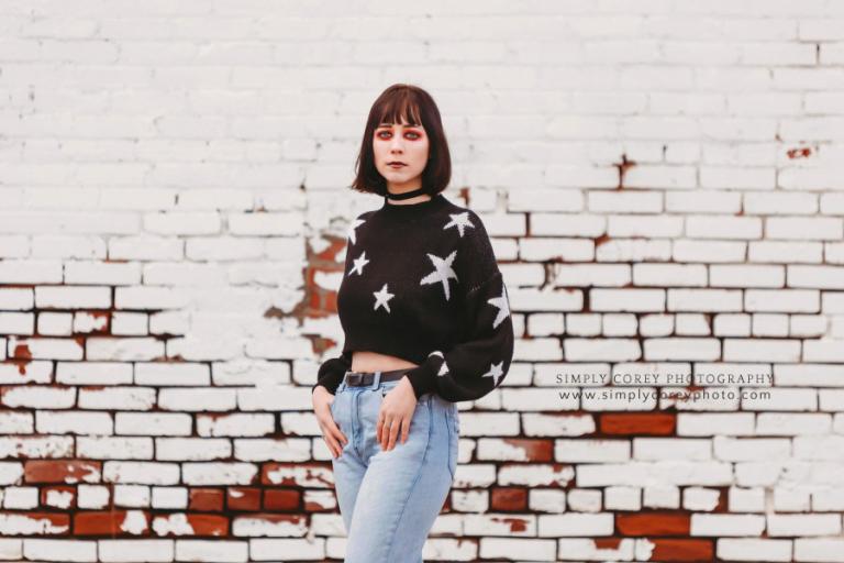 Atlanta photographer, girl in red makeup by white brick wall