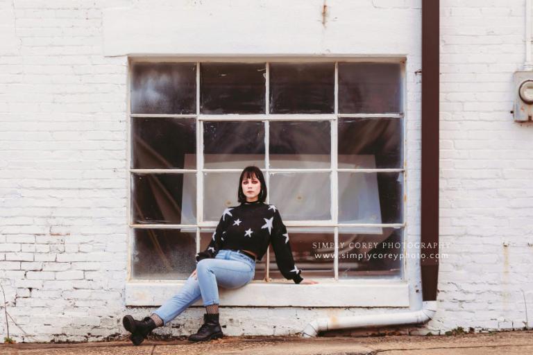 Douglasville photographer, downtown session by big window on brick wall