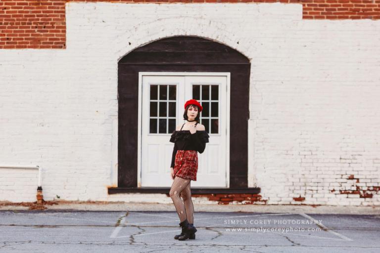 Newnan photographer, girl in red downtown by white brick wall