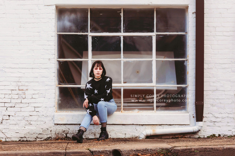 Newnan photographer, urban session by big window and brick wall