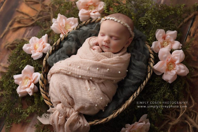 Douglasville newborn photographer, swaddled baby in basket with flowers