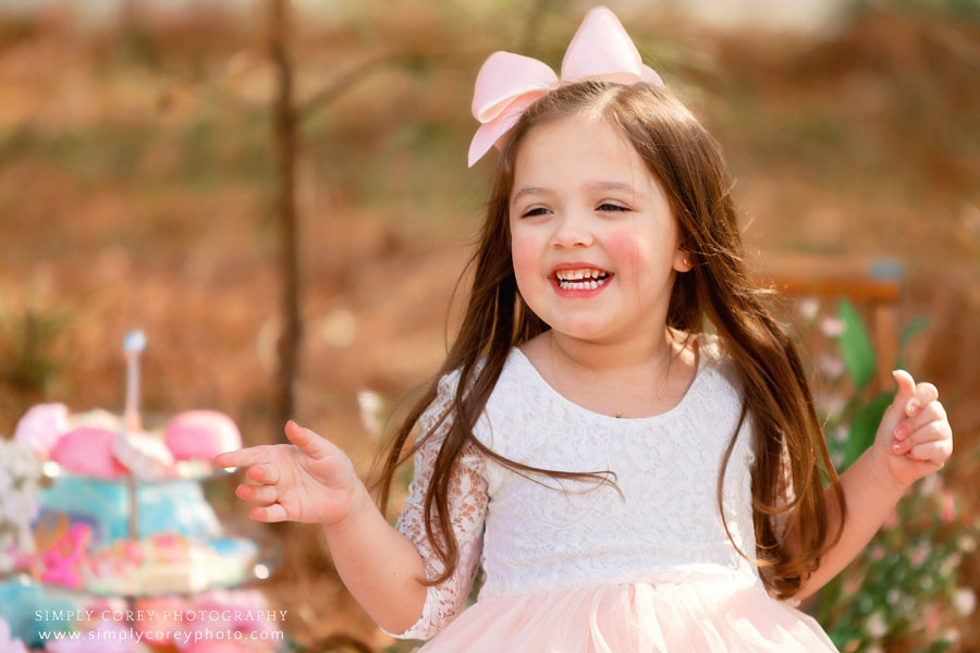 Carrollton children's photographer, girl smiling at outdoor tea party