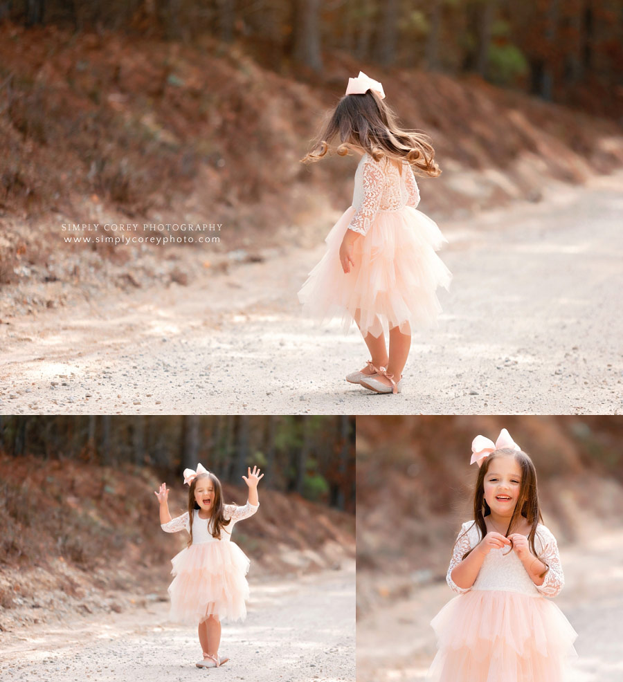 Douglasville children's photographer, girl twirling outside in pink dress
