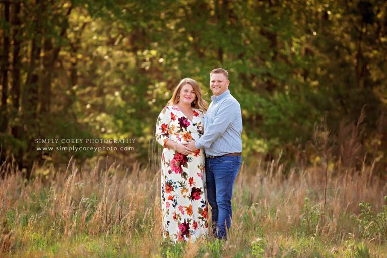 Carrollton maternity photographer, couple outside in field with tall grass