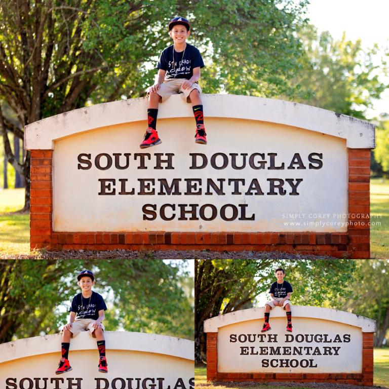 children's photographer near Villa Rica, elementary graduate with school sign