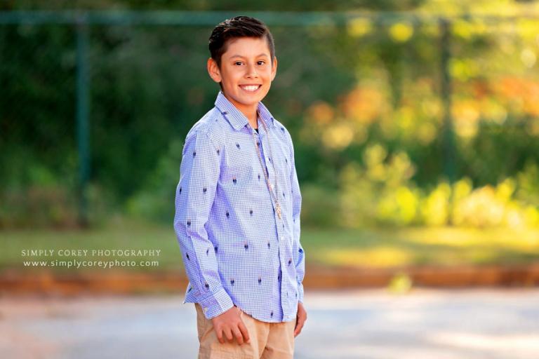 West Georgia photographer, child outside elementary school for graduation