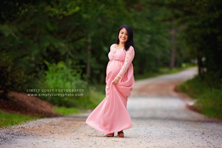 Newnan maternity photographer, mom twirling dress outside