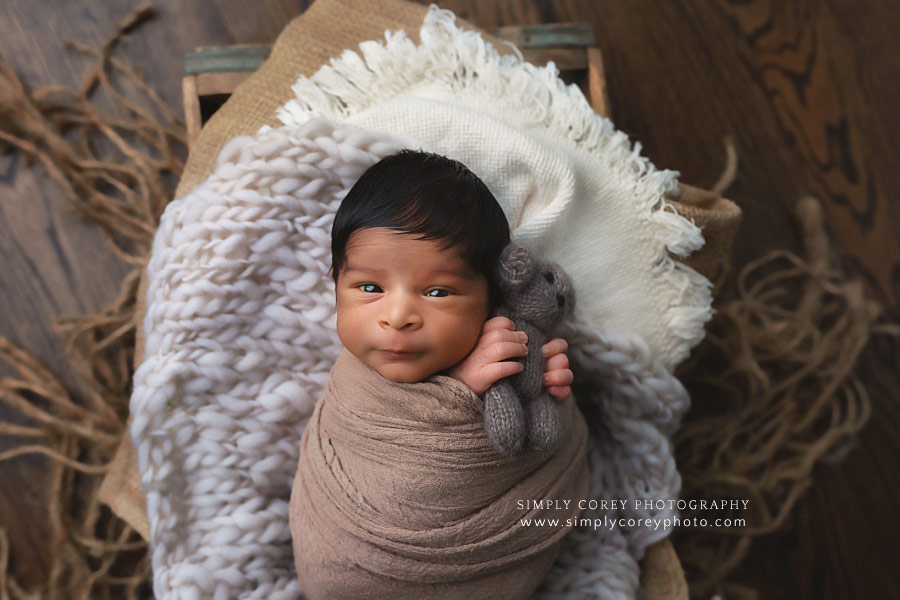 Atlanta newborn photographer, baby boy holding a brown teddy bear