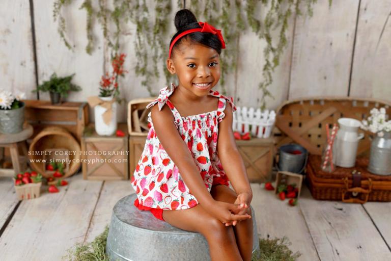 Newnan children's photographer, child in studio for a summer mini session with strawberries