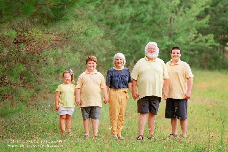 family photographer near Douglasville, grandparents and grandchildren outside in a field