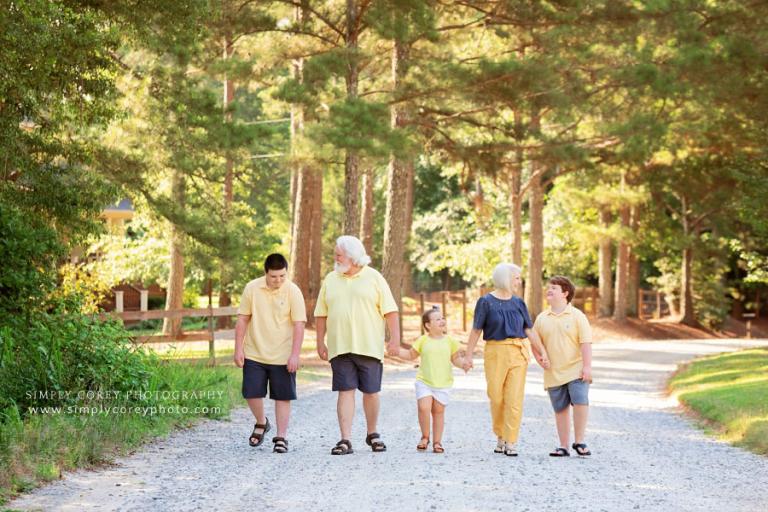 family photographer near Peachtree City, grandparents and grandchildren walking outside