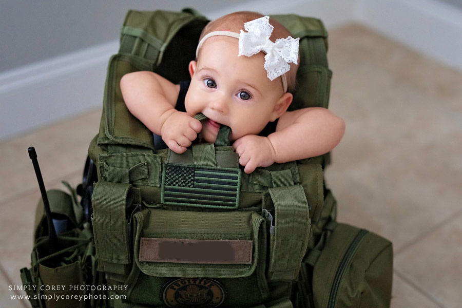 Atlanta baby photographer, baby sitting in tactical vest during in-home session
