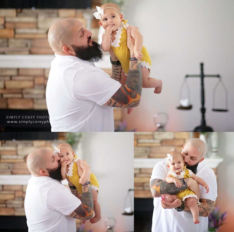Atlanta family photographer, dad holding baby during an in-home lifestyle photography session