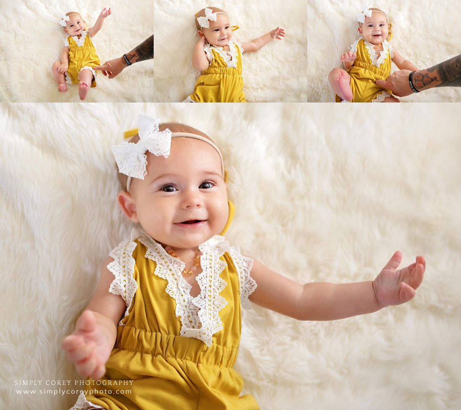 Villa Rica baby photographer, dad tickling baby girl to make her smile