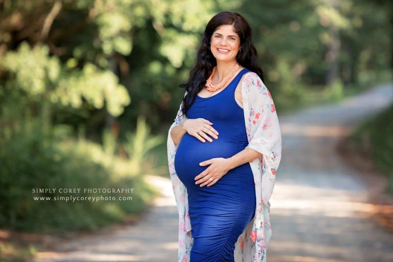 Newnan maternity photographer, expecting mom in blue outside on a country road