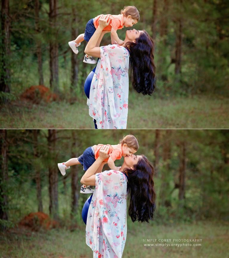 Newnan maternity photographer, pregnant mom holding a toddler above her head outside