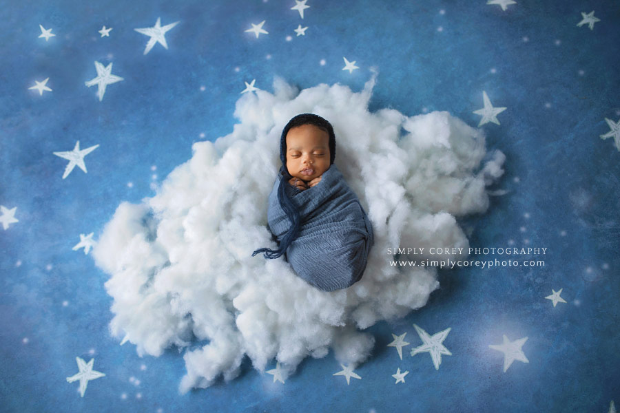 Atlanta newborn photographer, baby boy laying on a cloud with stars backdrop
