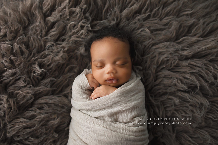 Atlanta newborn photographer, baby boy swaddled on flokati fur