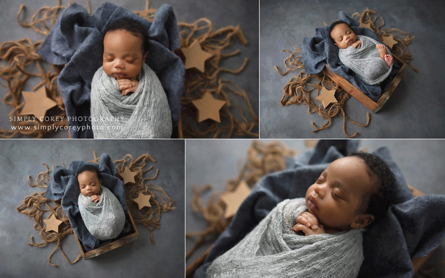 newborn photographer near Carrollton, GA; baby swaddled in grey with stars